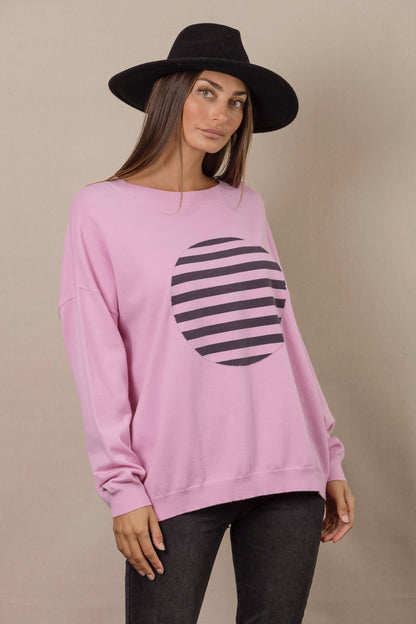 monochrome knit featuring black and pink striped circle on a pink base