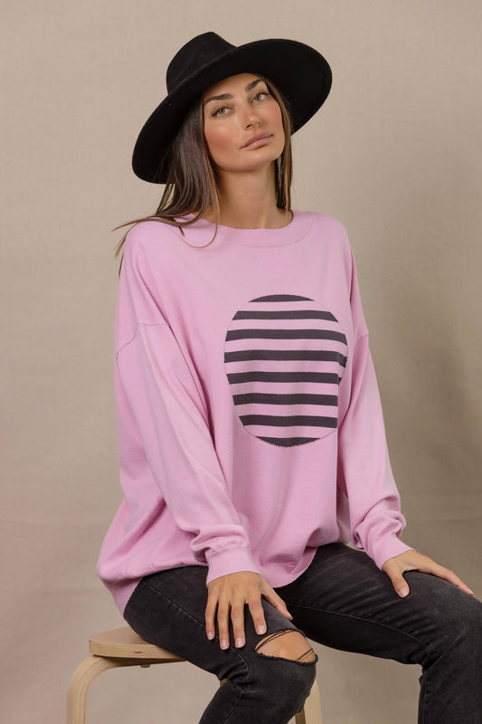 monochrome knit featuring black and pink striped circle on a pink base