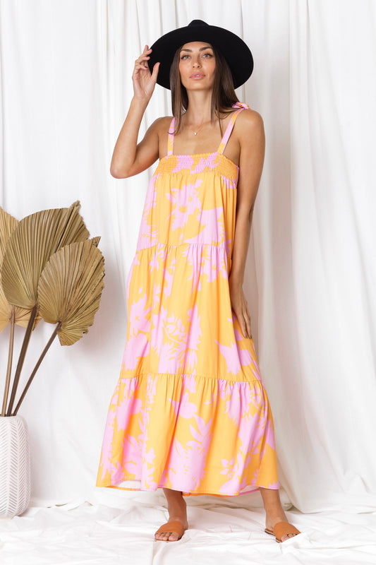 beach perfect dress with tie up shoulder straps, bright coloured pattern of orange and pink in a maxi length