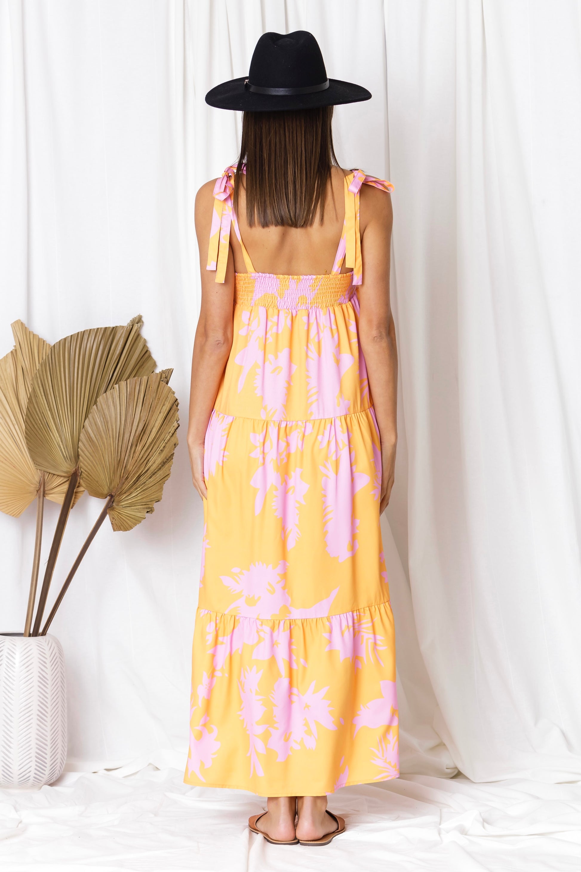 beach perfect dress with tie up shoulder straps, bright coloured pattern of orange and pink in a maxi length