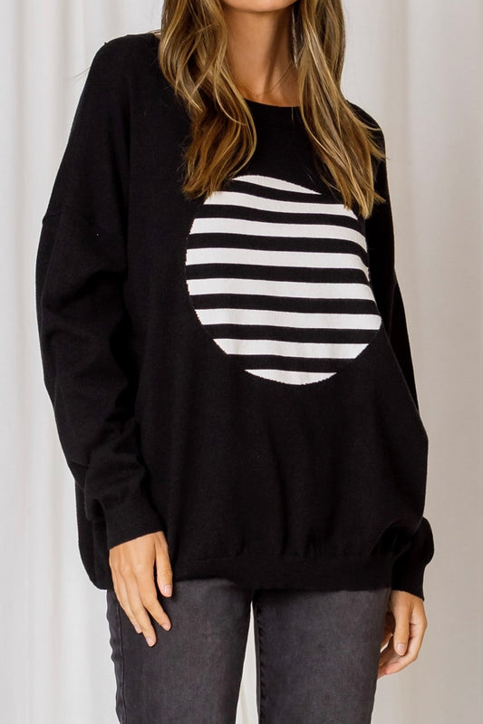 monochrome knit featuring black and white striped circle on a black base